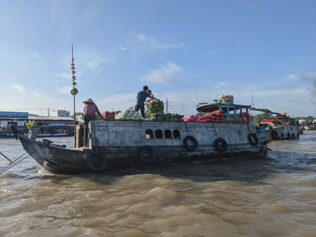 Boat loaded with fruits and vegetables at Cai Rang floating market in Vietnam.