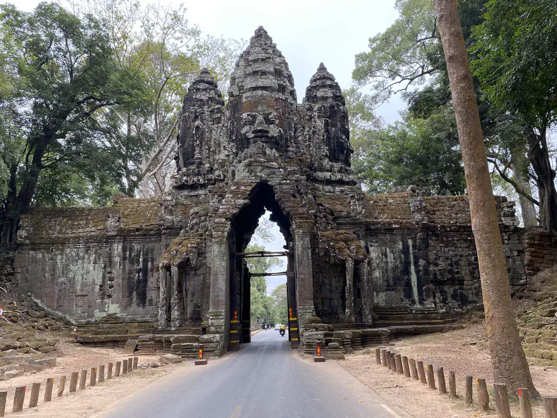 Stone gateway with large carved faces at Angkor Thom, Cambodia.