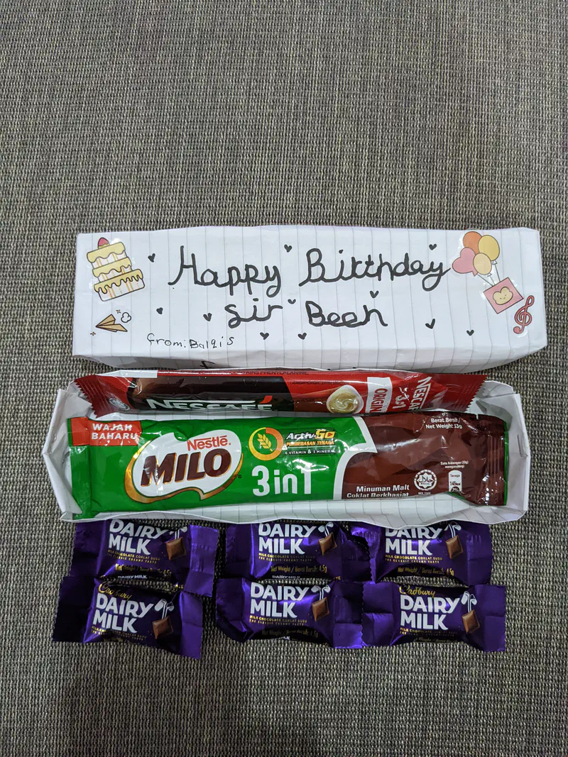 Birthday gift box with Milo sachets, Dairy Milk chocolates, and a handwritten note.
