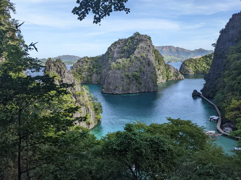 Scenic view of turquoise water surrounded by limestone cliffs and lush greenery.