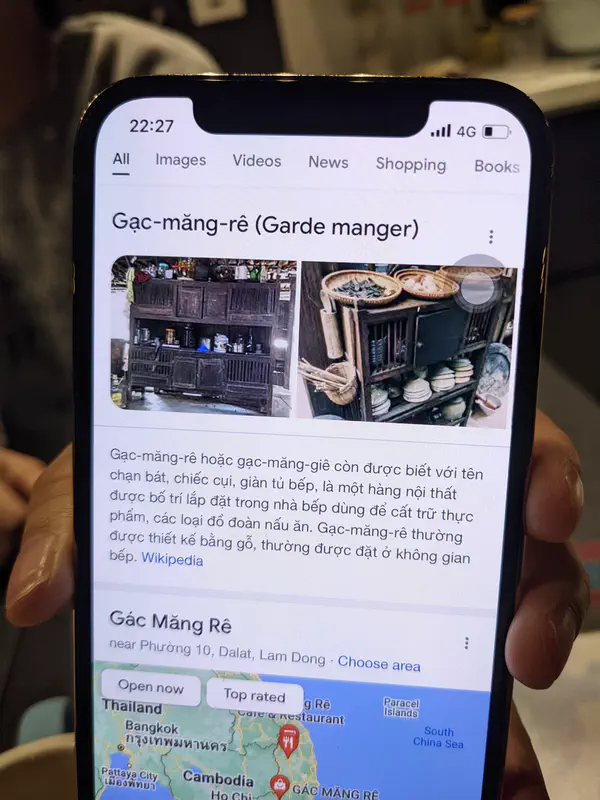 Smartphone screen showing a search result for “Gác-măng-rê” with images and text.
